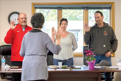 Recently elected trustees Tony Muzquiz, Shannon Bojorquez and Shane Orien take the oath of office at Wednesday night’s meeting of the Polson School Board.