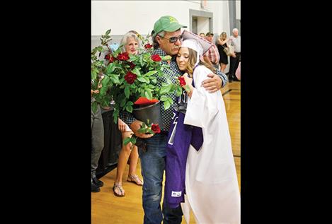 Sakoya Gaustad gives a hug to Max Krantz, father of classmate Brett Krantz who died in 2015.