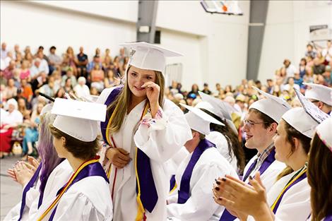 Salutatorian Aislynn Love wipes a tear as she walks to the stage to deliver her address.