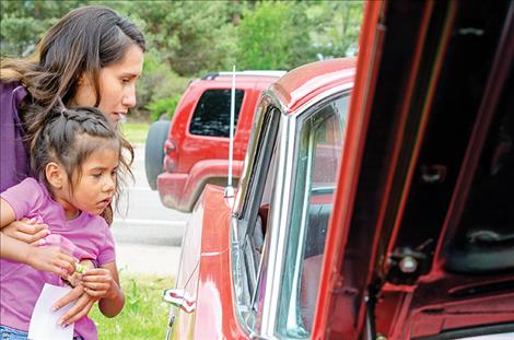 Autumn and Lee-onah Crumley look inside one of the cars during the show to pick their favorite. 