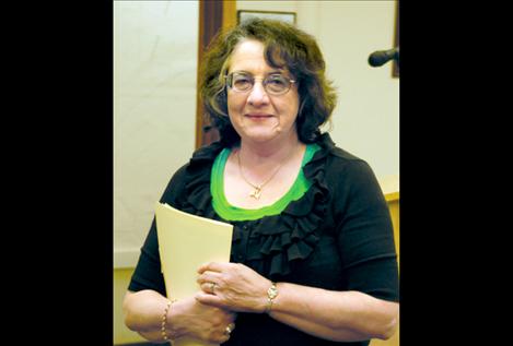 Polson City Treasurer Bonnie Manicke returns to her seat after delivering her resignation.