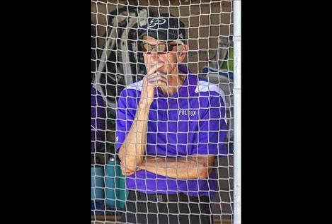 Coach Larry Smith watches his team from the dugout.