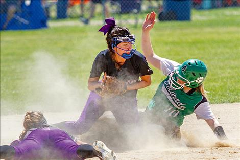 The Lady Pirates attempt to turn a double play.