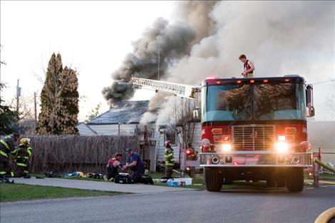 Polson, Ronan and Finley Point firefighters work into the night to put out a structure fire. They used approximately 8,000 gallons of water.