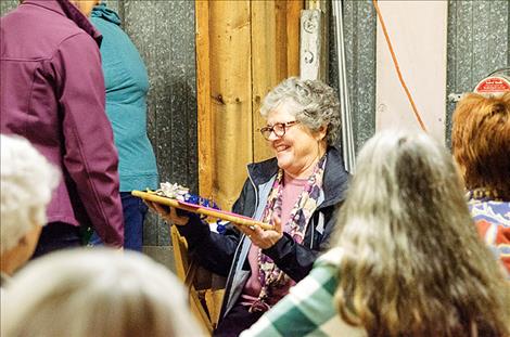 Ernie Ducheneaux receives a breadboard after a dozen years of volunteering as a board member with the Ronan Bread Basket.