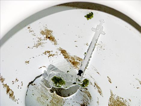 Officers found a syringe and small bag of marijuana in a toilet.