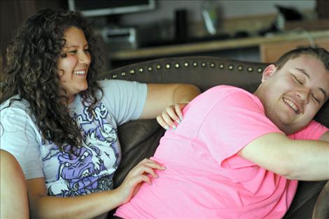 Jake and his 16-year-old sister Jenna smile and laugh during a back rub turned tickle-fight at the Janssen residence. 