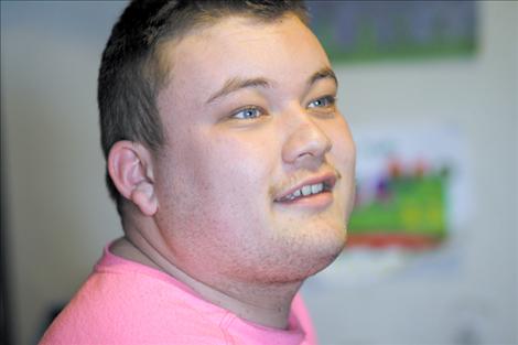 Jake Janssen smiles while looking at his massive collection of Thomas the Tank Engine toys. Now 18, Jake will graduate from Ronan High School this spring. 