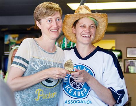 Jen “The Skipper” Kern, left, is presented the Women’s F.L.R.S.C. Champion trophy.