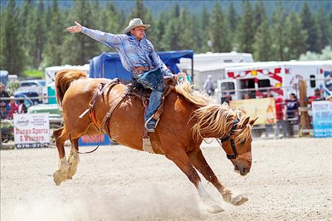 Cameron Brown rides a bronc in the rodeo