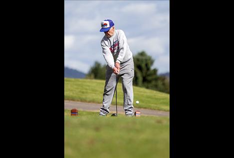 Dick Moore launches a ball during the golf ball driving competition.