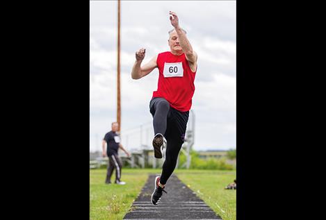 Terry Souhrada goes long during the long jump.