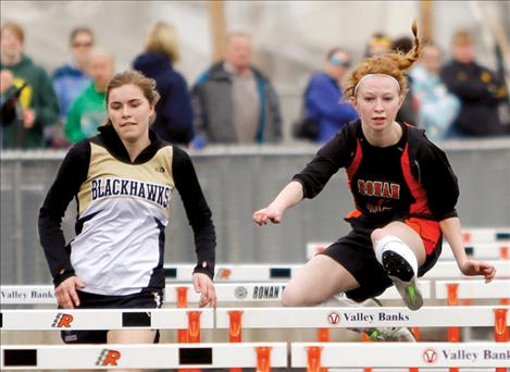 Alex Dennis flies over a hurdle in front of a Seeley-Swan runner at the Ronan Invitational last month.