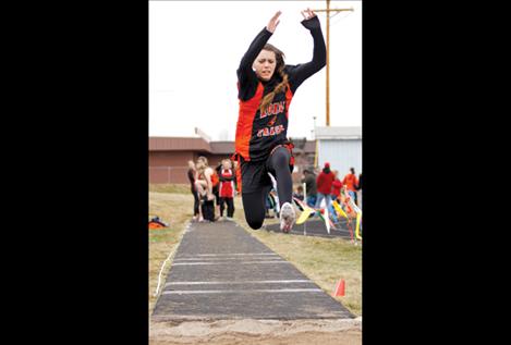 Sydney Castor competes in the long jump.