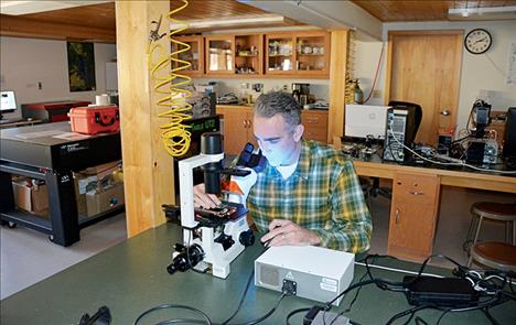 Cody Youngbull, research professor and inventor of the DNA Tracker, works in the environmental sensor lab at UM’s Flathead Lake Biological Station.