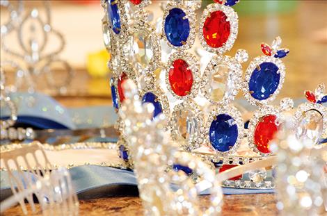 Several crowns from past wins are set out on the table.  