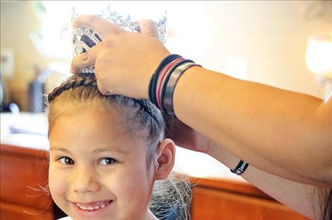 Amani Antoine gets the crown she  won in the Our Little  Miss Montana  competition secured  on her head. 