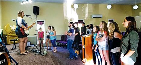 Youth group members worship and sing songs at the Cornerstone Faith Center.  