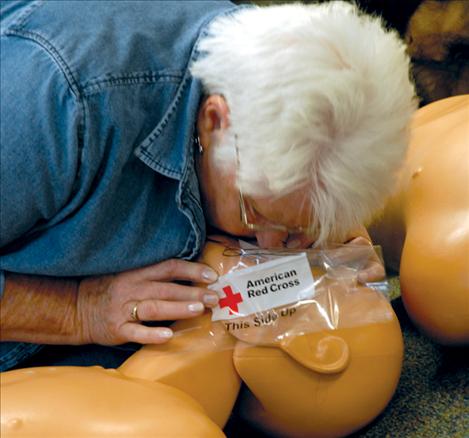 Sue Henderson practices CPR on a dummy at the American Red Cross Training Institute held over the weekend at  the Fairgrounds Fire Station.  