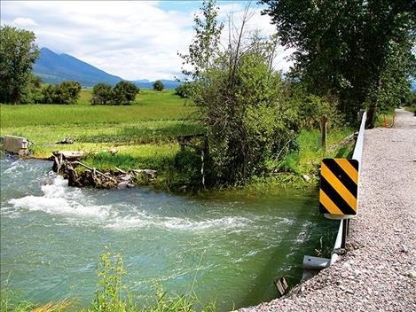 Floodwaters from recent rainstorms caused damage to Delaney Way near McDonald Lake Road in Charlo. 