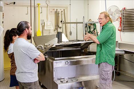 Joe Arnold of Flathead Lake Cheese explains the cheesemaking process to visitors.