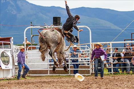 An angry bronc catapults a rider into the air. 
