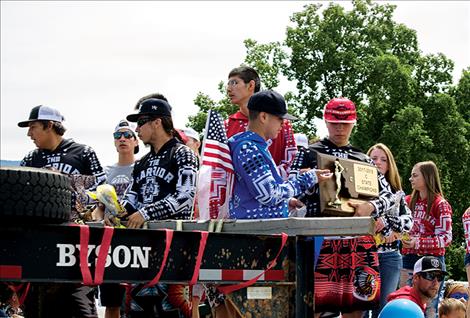 The Arlee Warriors ride on a float during a Fourth of July  parade to bring awareness to suicide prevention and  continue to be role models in the community. 