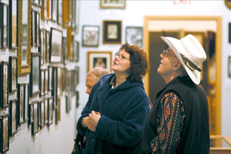 Bud Cheff Jr. tells visitors Larry and Cecilia Hollinder the stories behind hundreds of black and while photographs adorning the museum walls. Many artifacts come from either Cheff’s close family or the personal collection he started when he was a child.