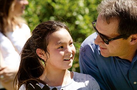 Montana Gov. Steve Bullock visits with a child at the Arlee Community Center on July 24.