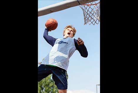  A street baller shows off his hoops during the 3-on-3 slam dunk contest.