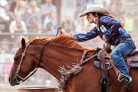 Right: Kyla Jaeger competes in ladies barrel racing on Saturday night.