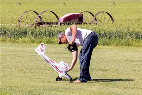 : A RC pilot retrieves his plane after a not so glamorous landing.