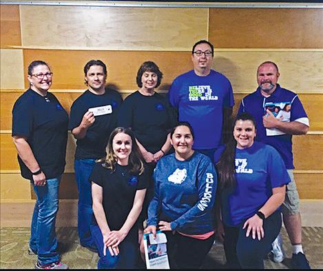 Principal Shawn Hendrickson stands (center) with teachers and staff members at OPI's award ceremony held at Montana State University in June. The St. Ignatius School District was the first school to get a Platinum Award two years in a row and the first reservation school in the state to get it.