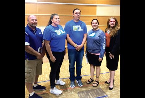 Principal Shawn Hendrickson stands (center) with teachers and staff members at OPI's award ceremony held at Montana State University in June. The St. Ignatius School District was the first school to get a Platinum Award two years in a row and the first reservation school in the state to get it.