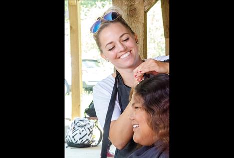 Holly Oakland of Rootz Salon gives one of more than a dozen haircuts during the event.