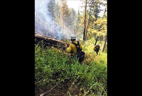 CSKT Division of Fire crews work to build a fire line around a quarter acre fire.