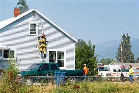 Ronan volunteer firefighters respond to a house fire on Wednesday. 