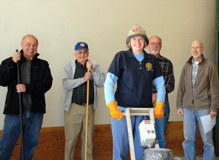 Keith Urbach, Rotary president elect, left, Ken Siler, Rotary president, Jules Clavadetscher, past president, Sharon, Fulton, past president, front, present a check to Bryan River, Loaves and Fish Food Pantry director, for flooring in the receiving area.  