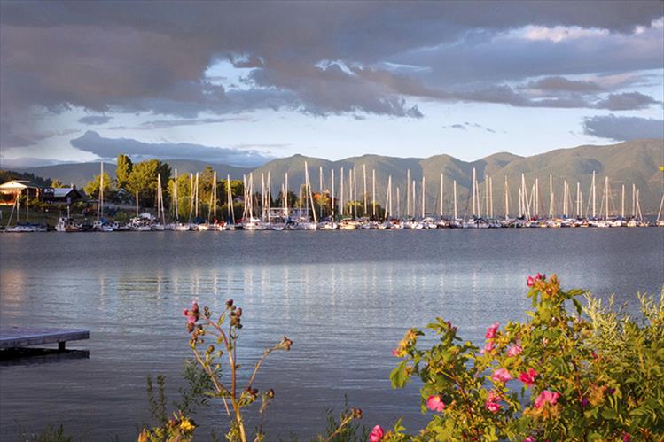 Sailboats docked at the Dayton Yacht Harbor reflect the warm glow of an early July sunset.