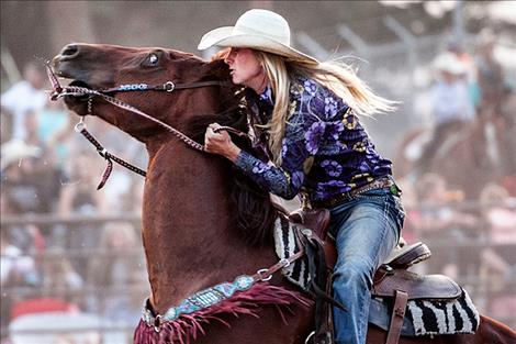 Paula Symington competes in the Ladies Barrel Race.