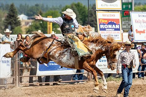 Saddle bronc rider Andrew Evjene holds on for a 78-point first place ride.