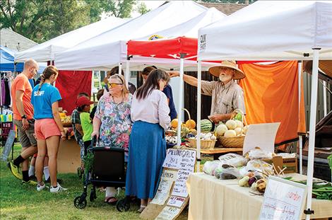 Fruits and vegetables wait for  customers at the Ronan Farmers  Market on Thursday. Markets across the county also have  produce for sale. 