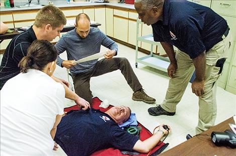 Ravalli County Sheriff’s Sgt. Jake Auch helps the mock victim during a training exercise.