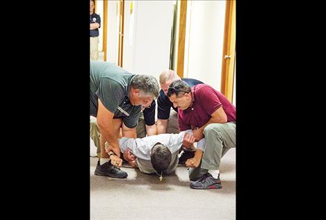 Emergency response teams learn to lift a victim.