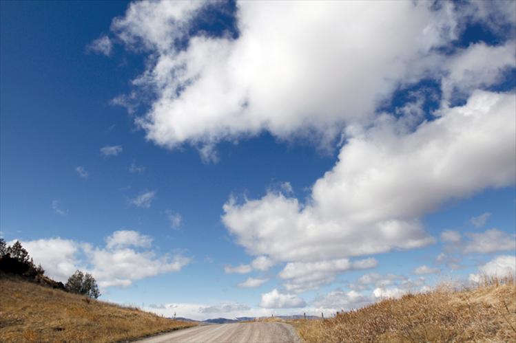 Fluffy white clouds on a background of bluest blue herald warmer days to come in the Mission Valley.