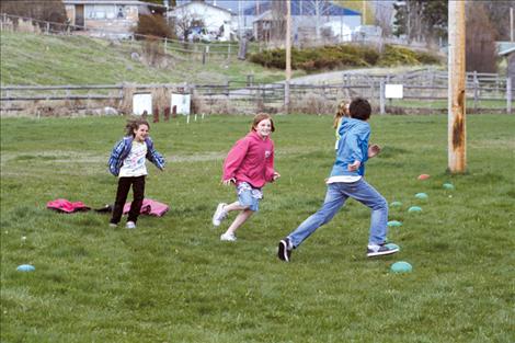 While the adults were busy being serious, St. Ignatius children took advantage of the rain and wet conditions with a game of tag.