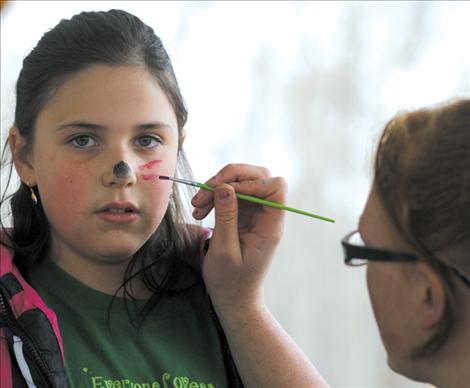 Jazmin Durffel gets a "Cat Woman" makeover during the Earth Day event.