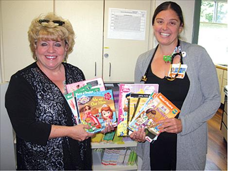 Providence St. Joseph Medical Center  pediatrician Emily Hall, DO, recently  accepted a donation of children’s books from Laura Burrowes, Lake County  Representative for the Community Action Partnership of Northwest Montana. 