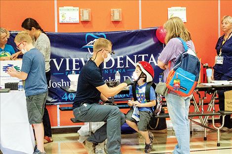  Dr. Joshua Ricks provides dental assessments for children at the fair. 