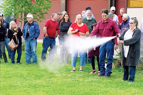 Steve Primm, People and Carnivores founder, shows participants how to use bear spray the correct way.